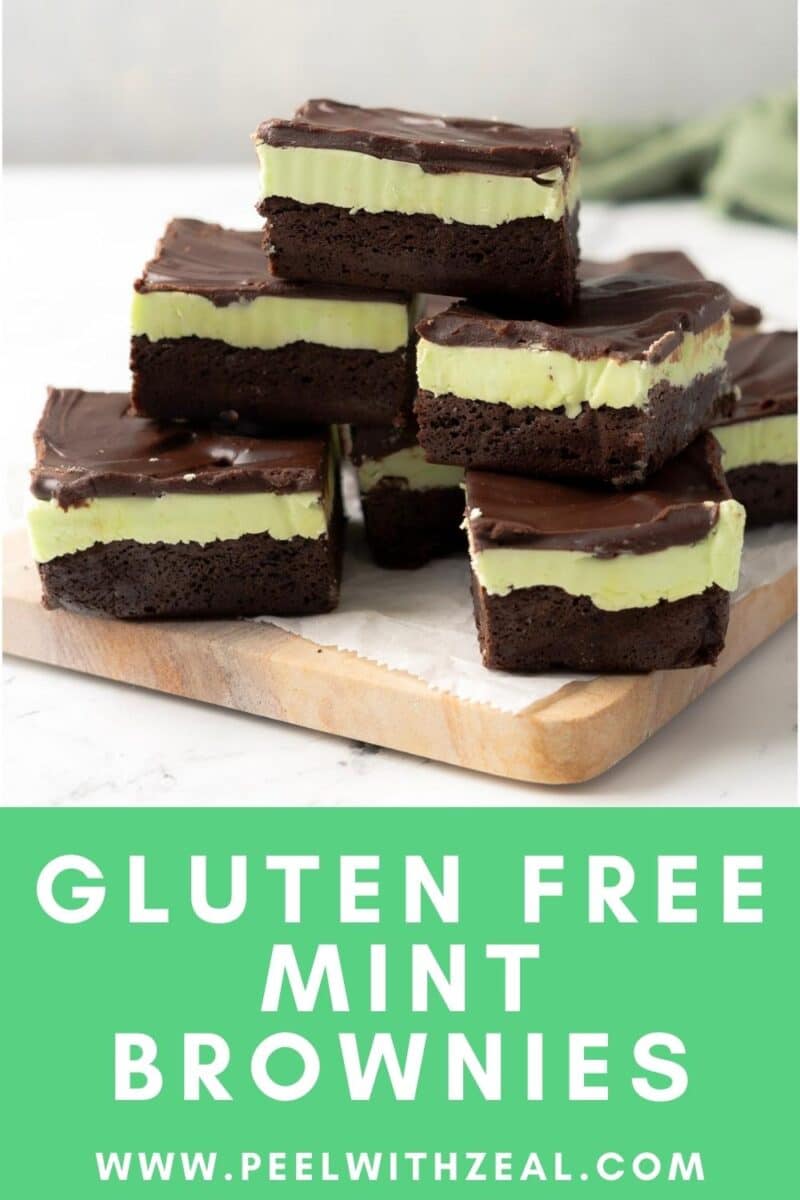 A delectable stack of gluten-free mint chocolate brownies, showcasing rich chocolate and refreshing mint layers, rests invitingly on a wooden board.