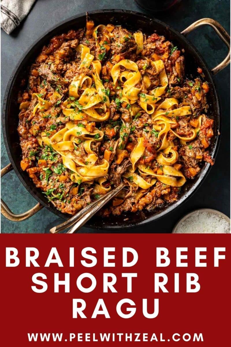 A skillet brimming with succulent short rib ragu and pasta, beautifully garnished with fresh greens. Discover more at peelwithzeal.com.