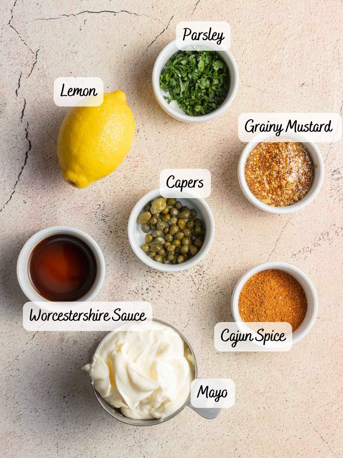 Labeled ingredients create a template for a delicious feast: lemon, parsley, grainy mustard, capers, Worcestershire sauce, Cajun spice, and mayo.