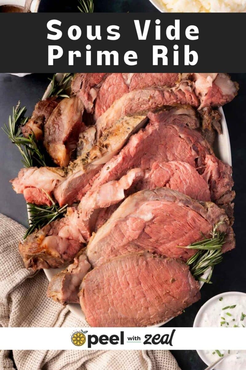 Sous vide prime rib is artfully sliced on a platter, garnished with sprigs of rosemary. Nearby, a bowl of mashed potatoes rests on a beige cloth, completing the elegant presentation.