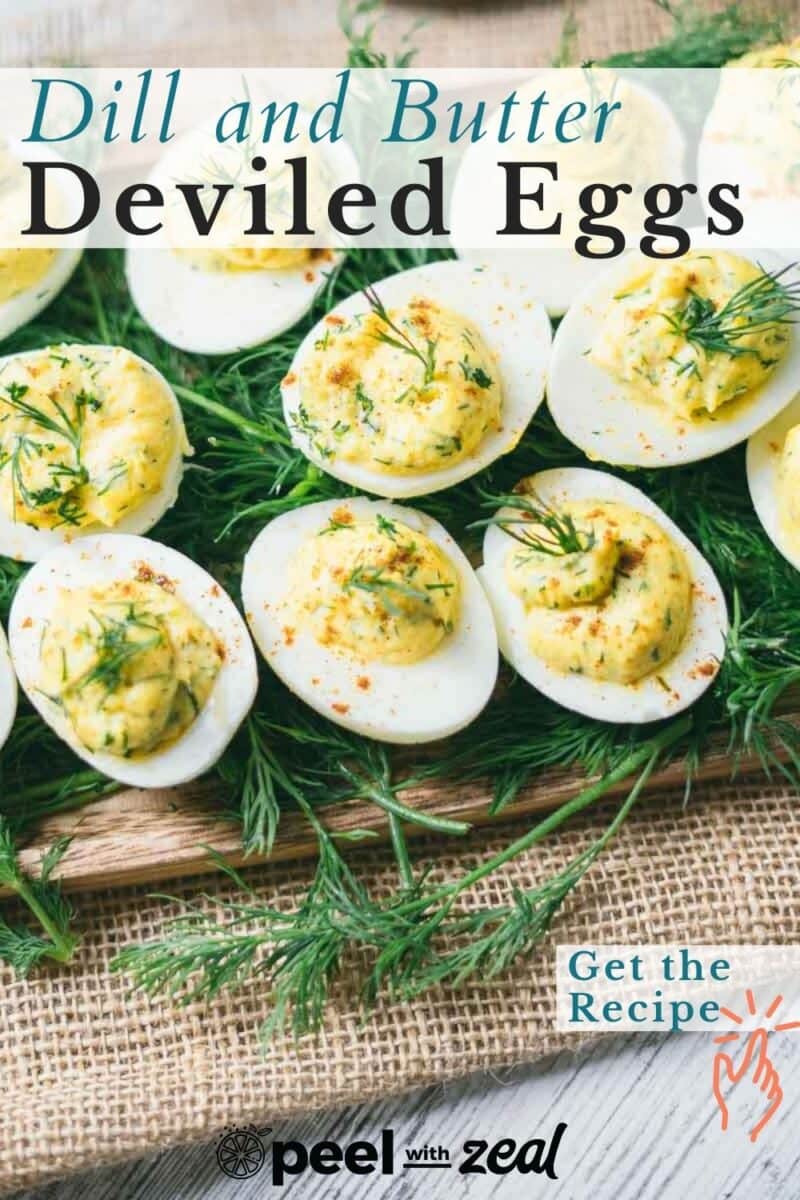 Deviled eggs garnished with dill on a wooden board, displayed on a bed of fresh dill, with the text "Dill and Butter Deviled Eggs" and "Get the Recipe.