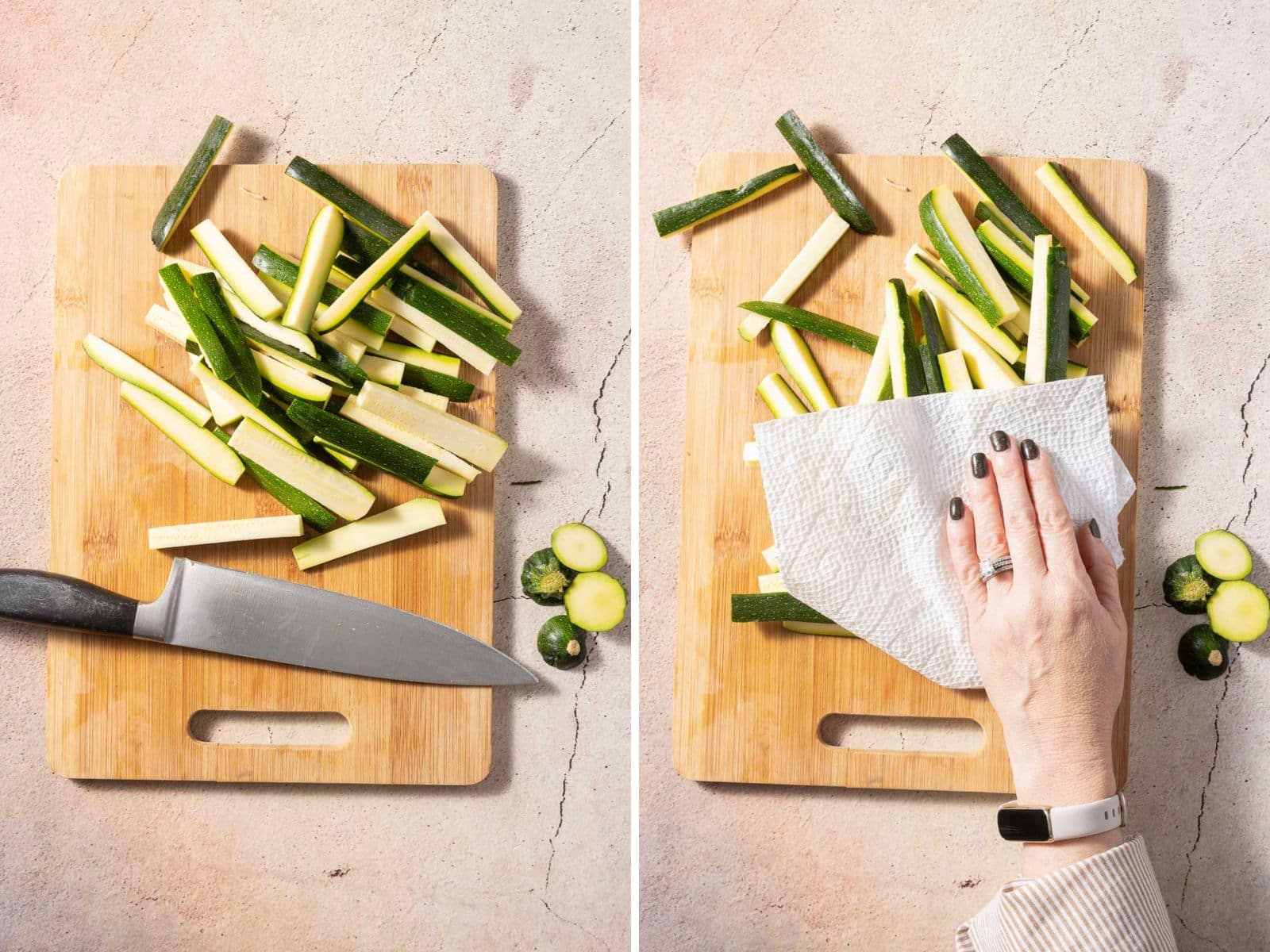 Sliced zucchini on a wooden cutting board with a knife; a hand uses a paper towel to pat the slices dry.