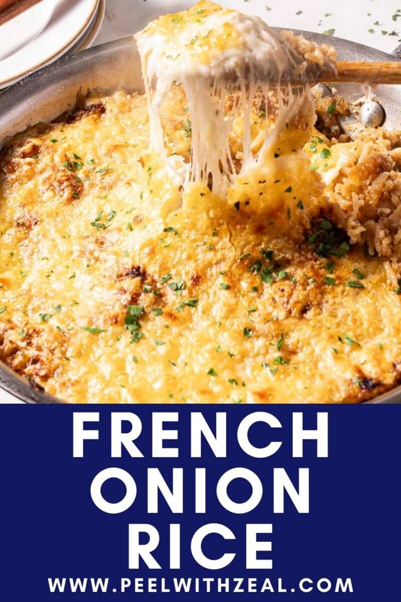 A skillet of French onion rice topped with melted cheese and garnished with herbs.