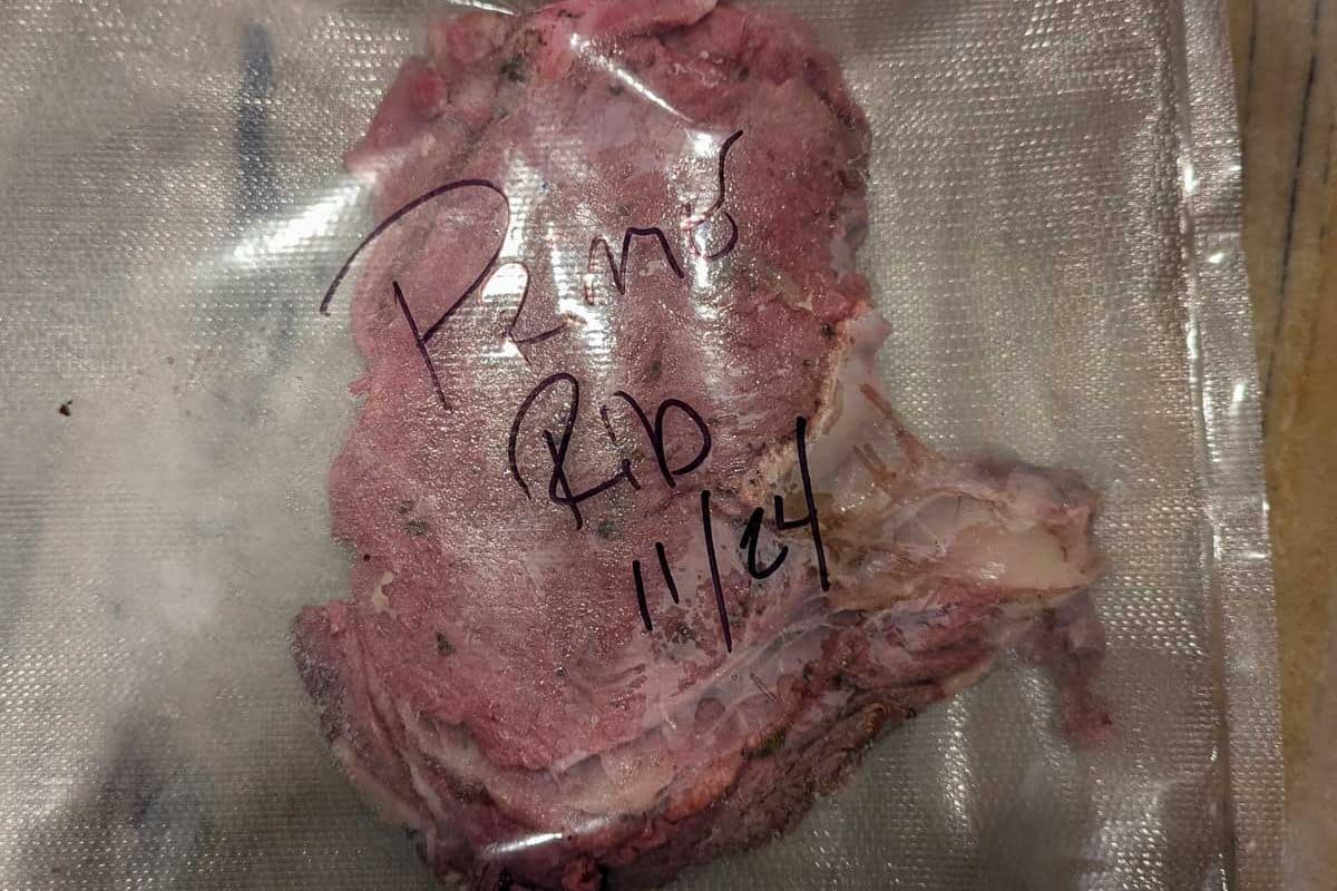 Vacuum-sealed piece of meat labeled "Prime Rib 11/24" in marker on the plastic.