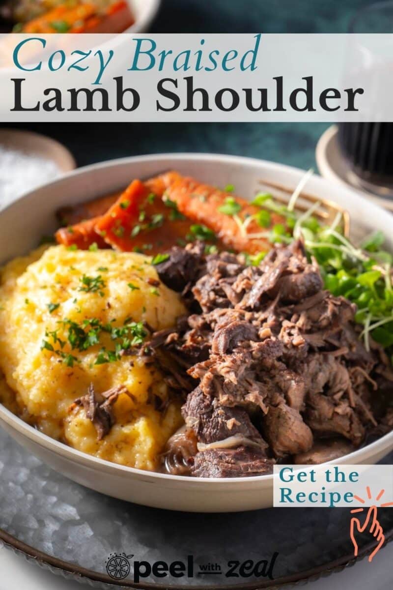 A bowl of braised lamb shoulder with mashed potatoes and vegetables, garnished with parsley.
