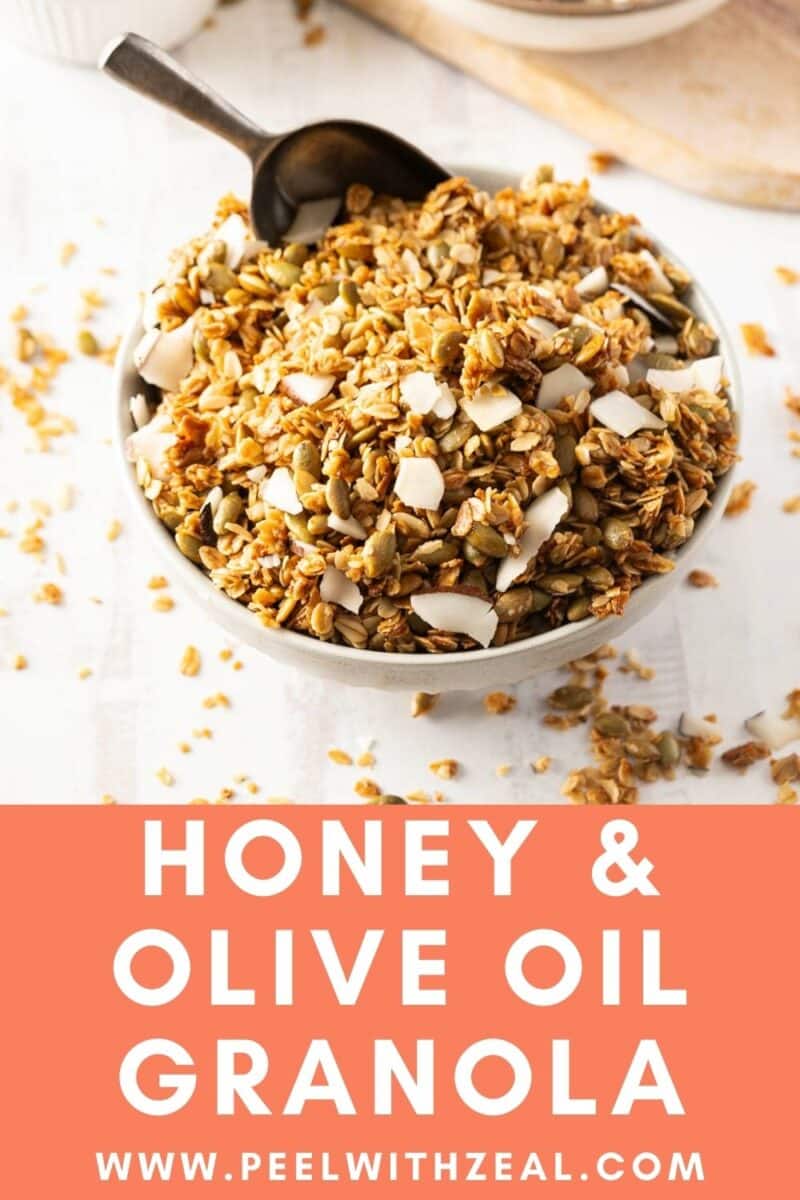 A bowl of granola with sliced almonds and seeds, served with a spoon. The text reads "Honey & Olive Oil Granola" with a website URL at the bottom.