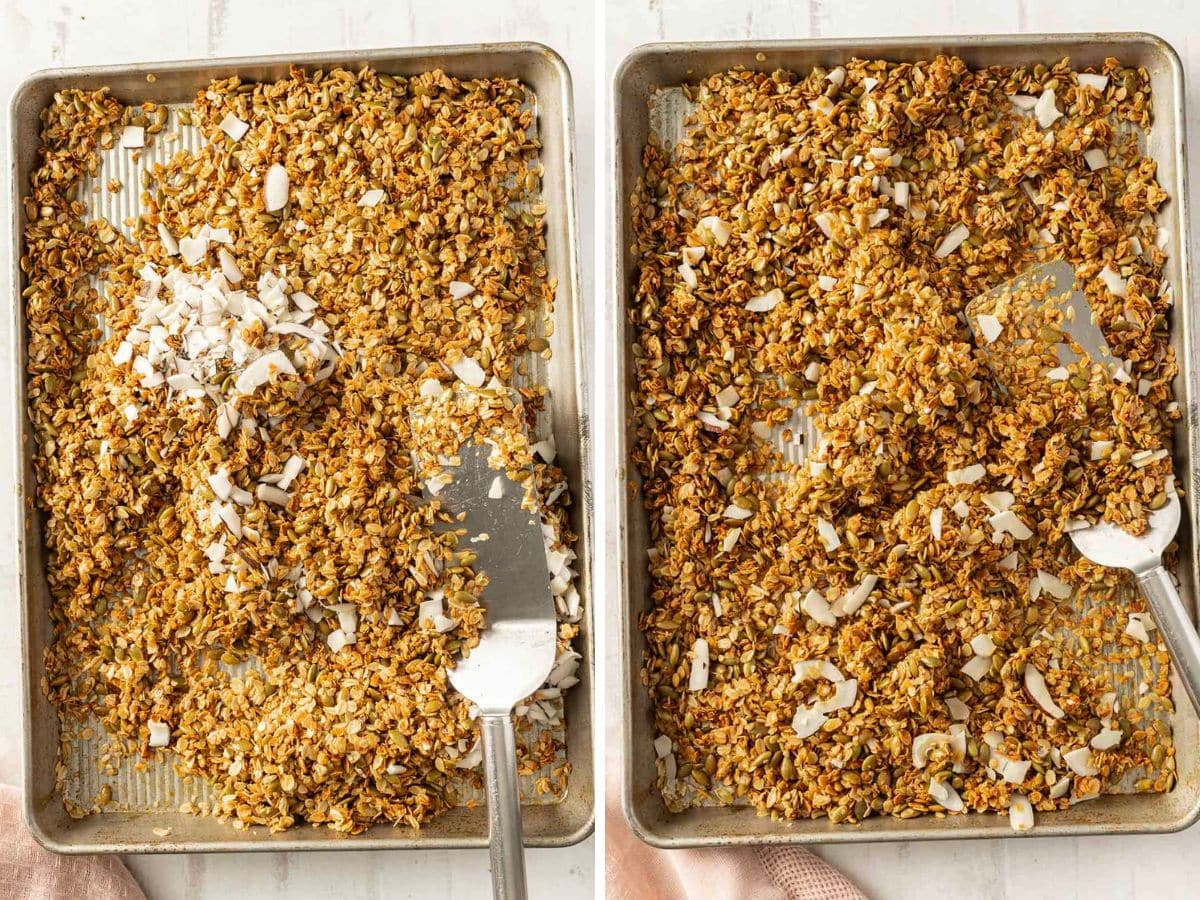 Two baking sheets with granola being mixed with coconut flakes using a spatula.