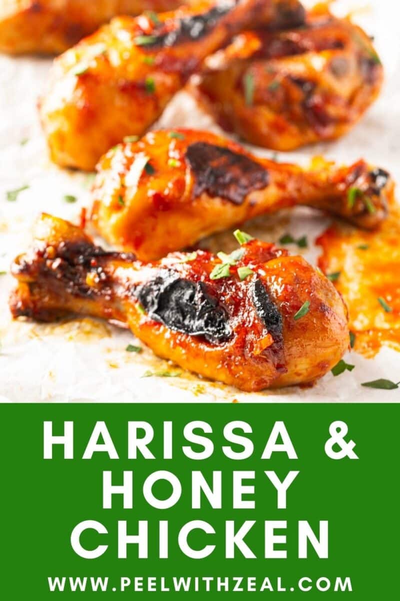 Close-up of glazed chicken drumsticks with herbs, featuring the text "Harissa & Honey Chicken" and a website link below.
