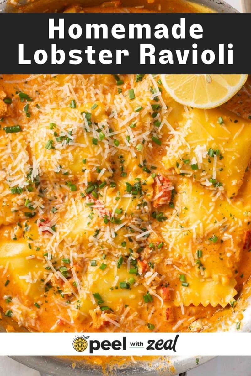 Lobster ravioli topped with cheese and herbs in a creamy sauce, presented in a skillet.