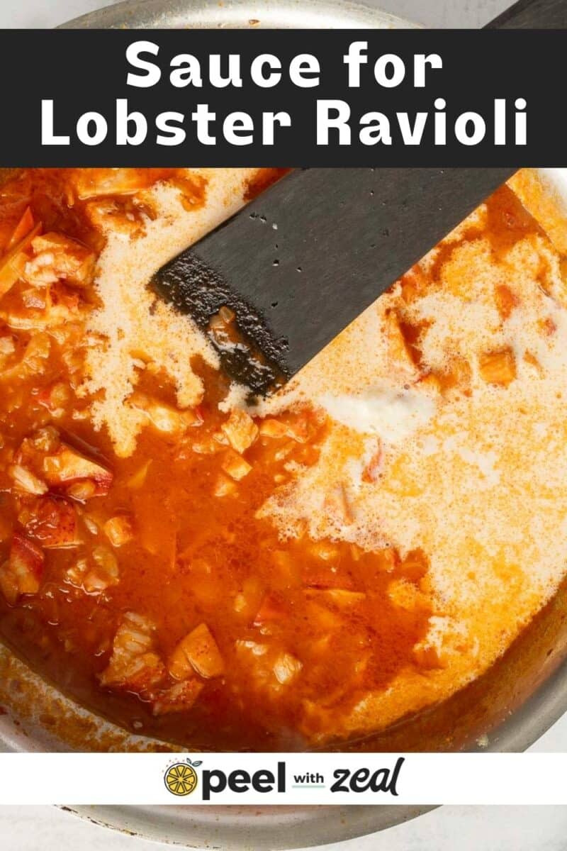 Close-up of a creamy tomato sauce with chunks of lobster in a pan, labeled "Sauce for Lobster Ravioli" at the top.
