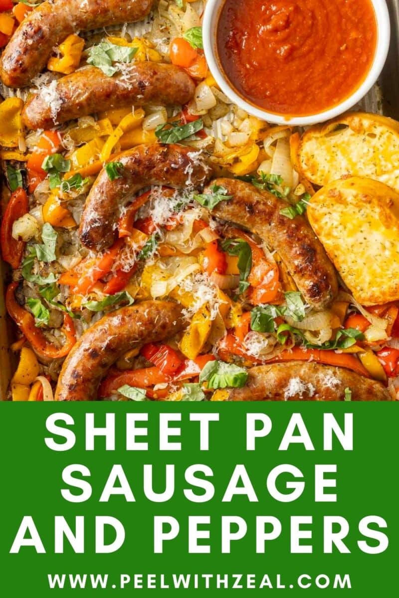 Sheet pan with roasted sausages, colorful bell peppers, onions, garlic bread, and a bowl of marinara sauce. Text overlay: "Sheet Pan Sausage and Peppers. www.peelwithzeal.com.