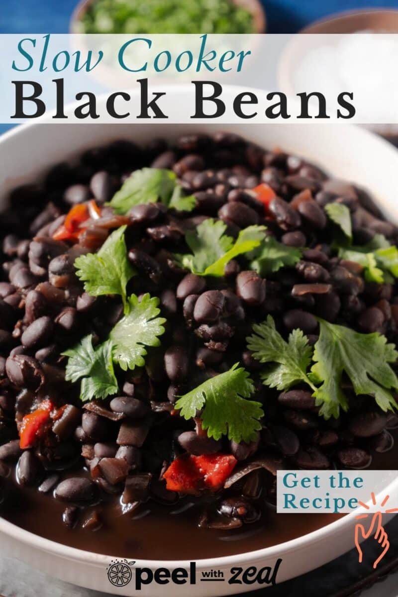 A bowl of slow-cooked black beans with red peppers and cilantro. "Slow Cooker Black Beans" text is on top, and "Get the Recipe" is noted on the side.