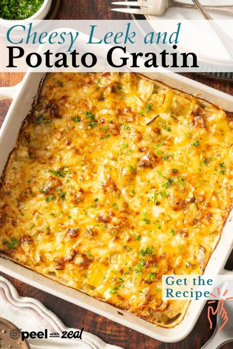 A golden-brown leek potato gratin, topped with melted cheesy goodness and a sprinkle of parsley, rests invitingly in a white baking dish.