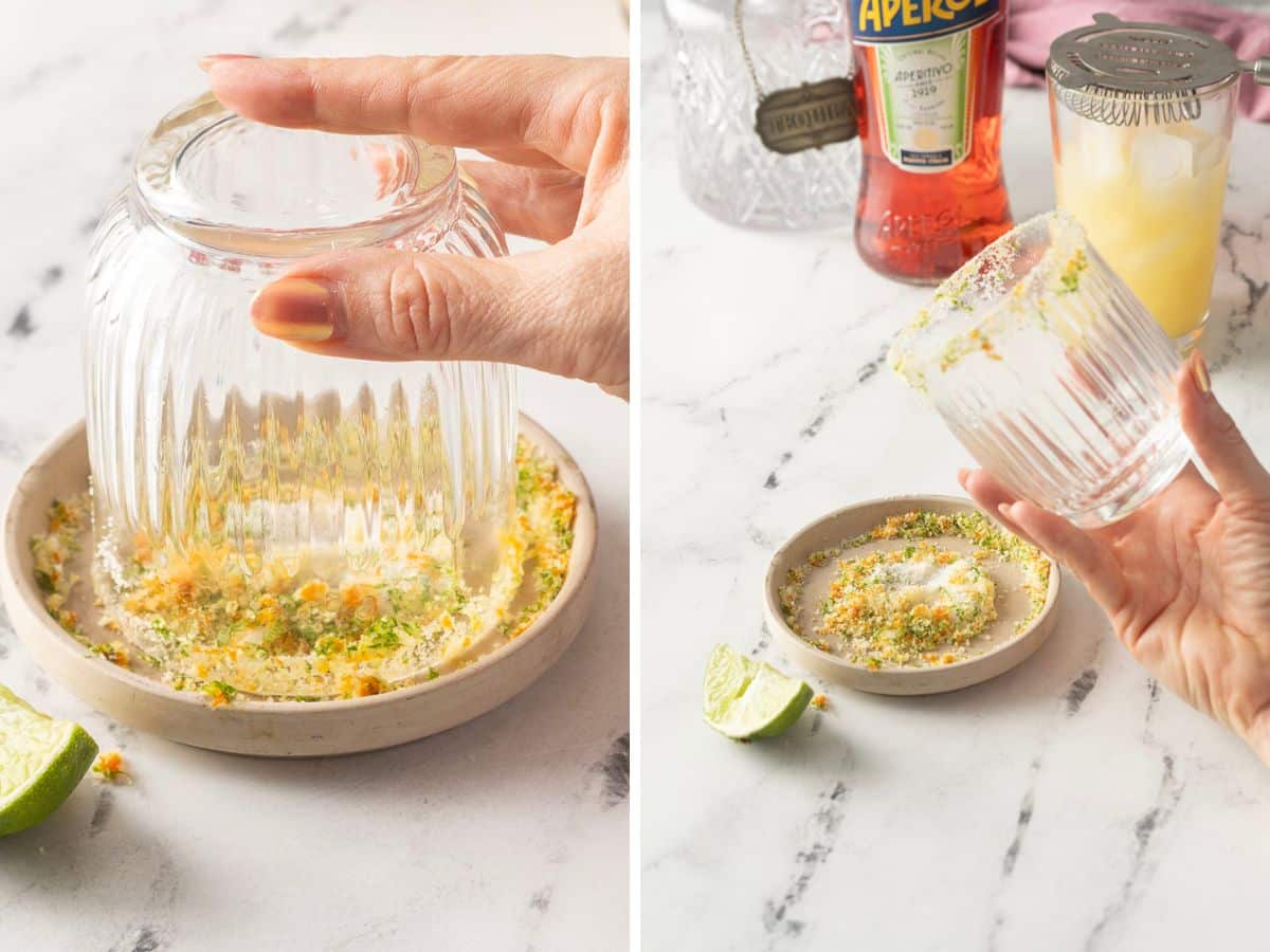  riming a glass with lime zest and salt for the perfect Margarita; a bottle of Aperol in the background.