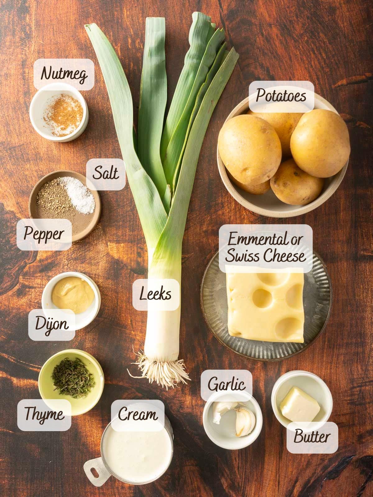 Indulge in a creamy Leek Potato Gratin with layers of leeks, tender potatoes, and Emmental cheese. A touch of garlic, Dijon mustard, and thyme enhances the flavors, while cream and butter create a rich texture. Seasoned perfectly with salt, pepper, and nutmeg for an irresistible dish.