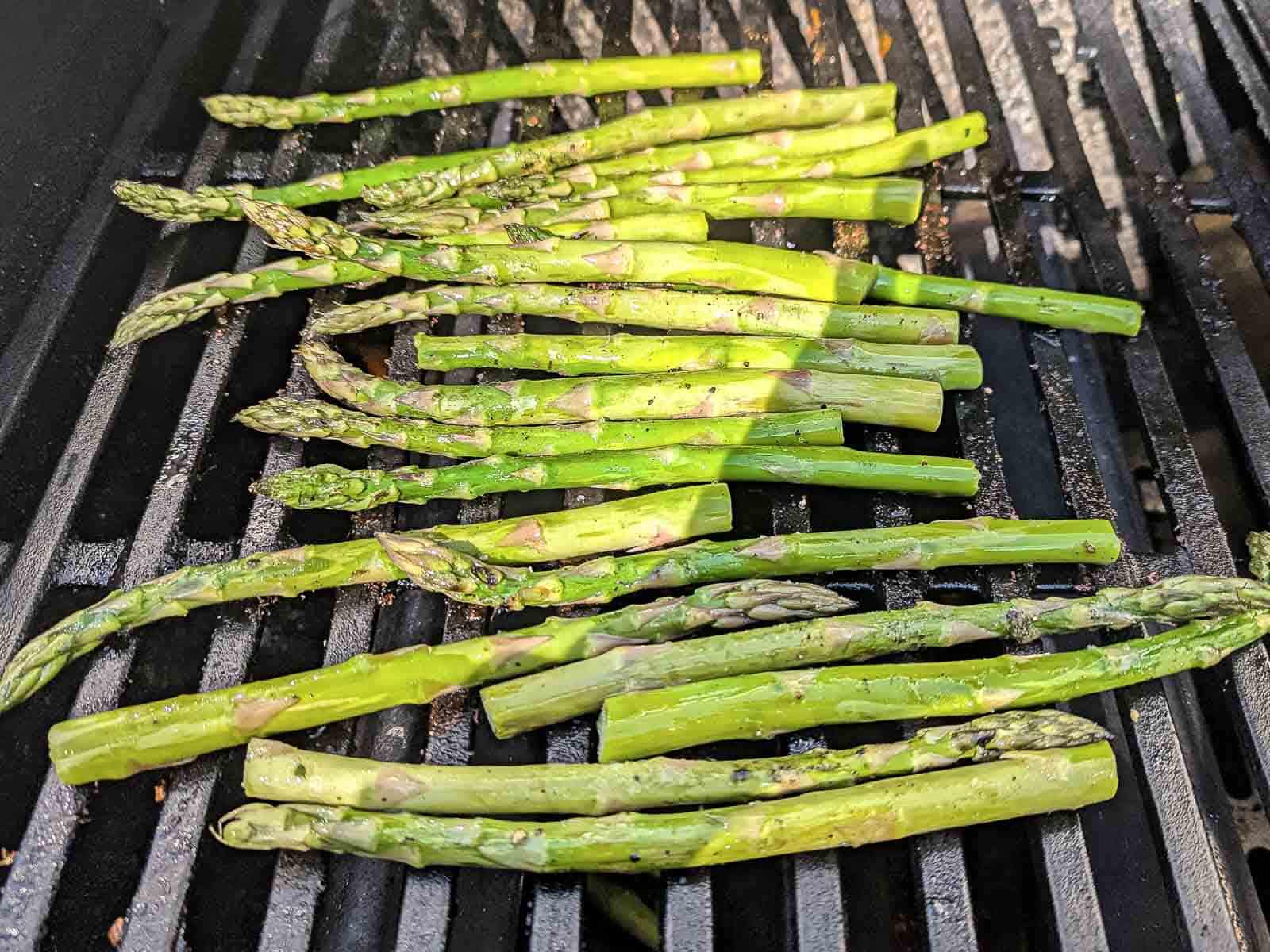 Sizzling on the barbecue, the asparagus spears.