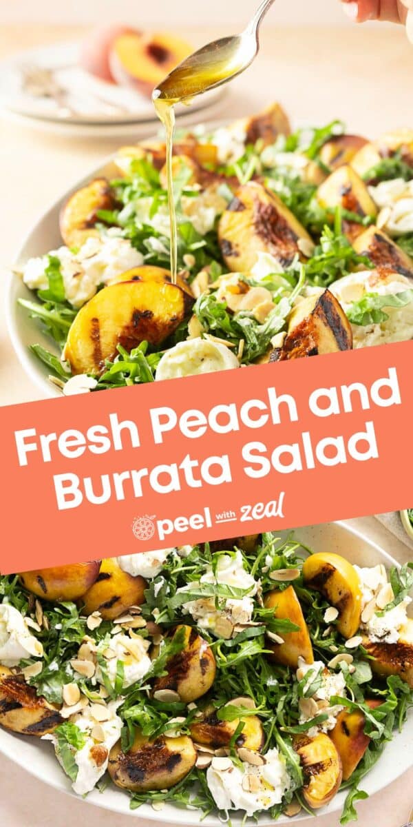 A hand drizzles dressing over a salad brimming with grilled peach slices and creamy burrata, garnished with greens and nuts.
