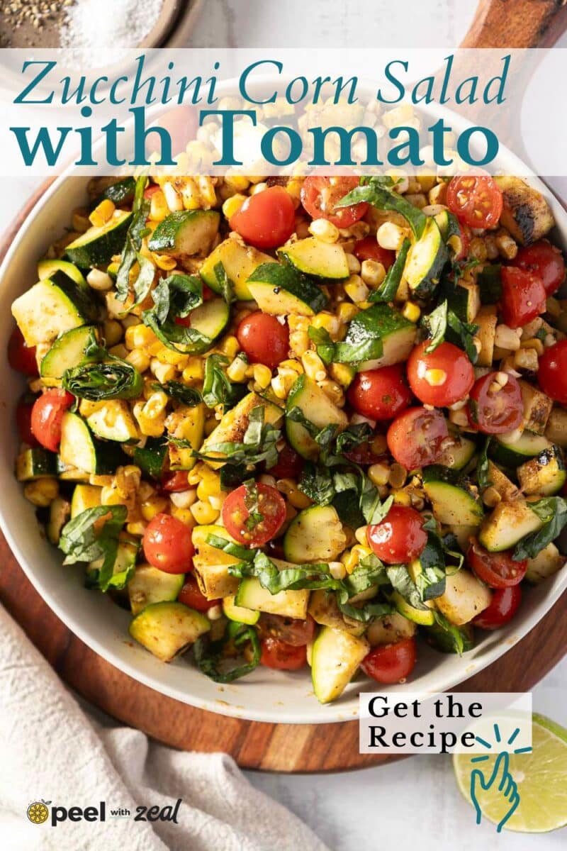 A bowl of corn and zucchini salad with cherry tomatoes, fresh herbs, and perfectly sliced zucchini pieces.