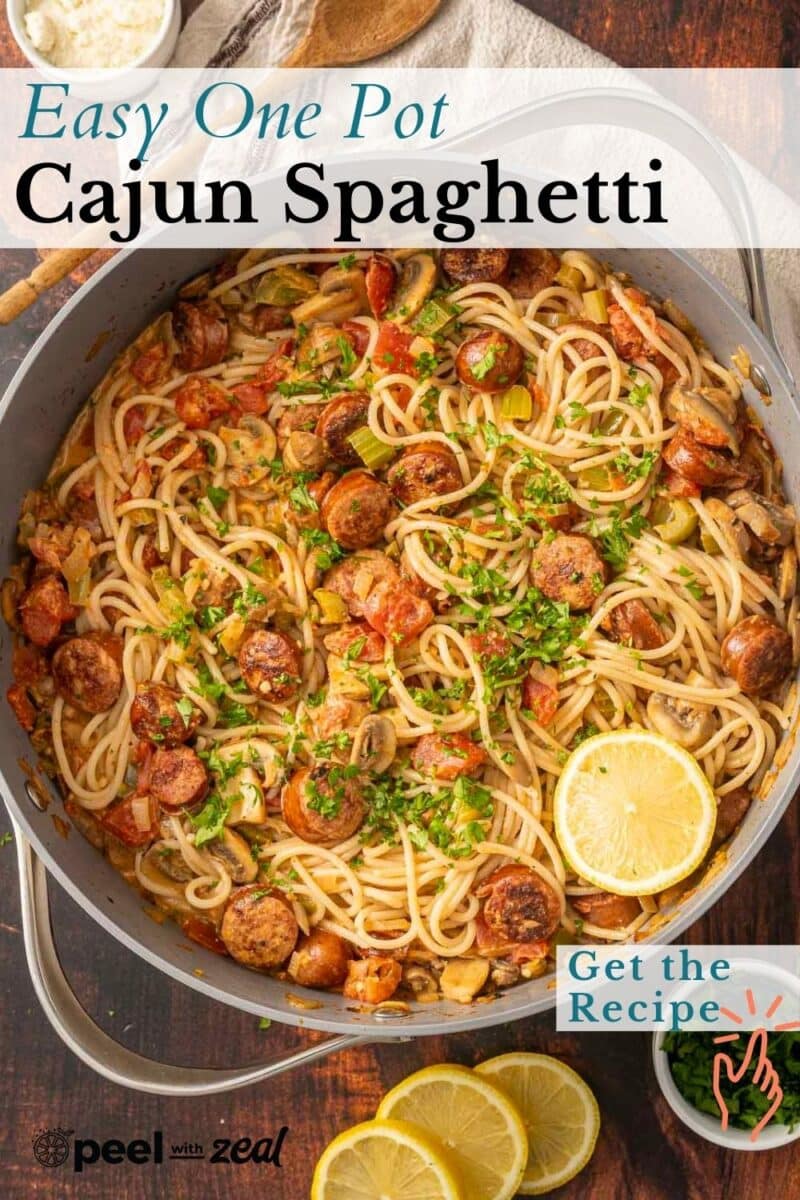 A skillet brimming with Cajun sausage spaghetti, enhanced by zesty lemons and a sprinkle of fresh herbs.