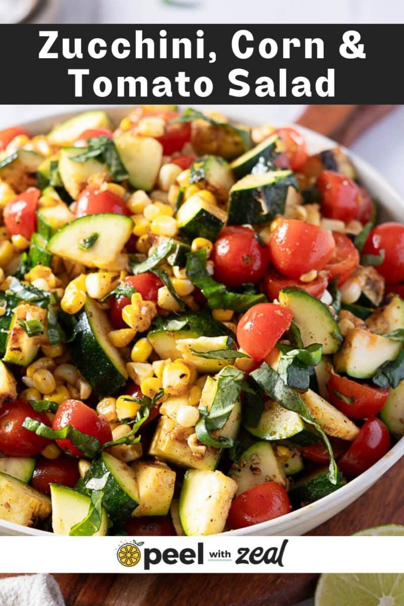 Bowl of corn and zucchini salad garnished with herbs. Text at the top reads "Zucchini, Corn & Tomato Salad," with "peel with zeal" logo at the bottom.