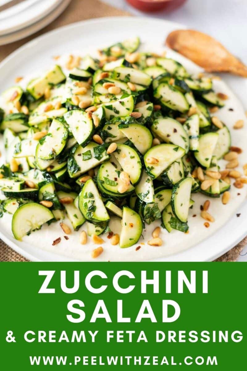 Zucchini salad with pine nuts and creamy feta dressing elegantly presented on a plate, text reads "Delicious Zucchini Salad & Creamy Feta Dressing.