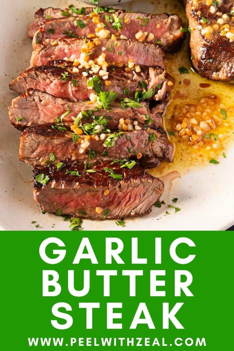 Sliced steak with buttery garlic goodness and herbs, elegantly served on a white plate.