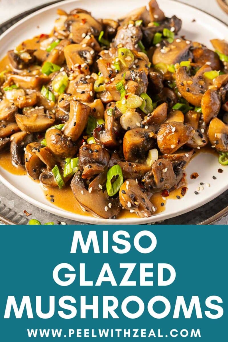 A plate of savory miso mushrooms glazed to perfection, garnished with sesame seeds and chopped green onions, sits above text that reads "Miso Glazed Mushrooms www.peelwithzeal.com".