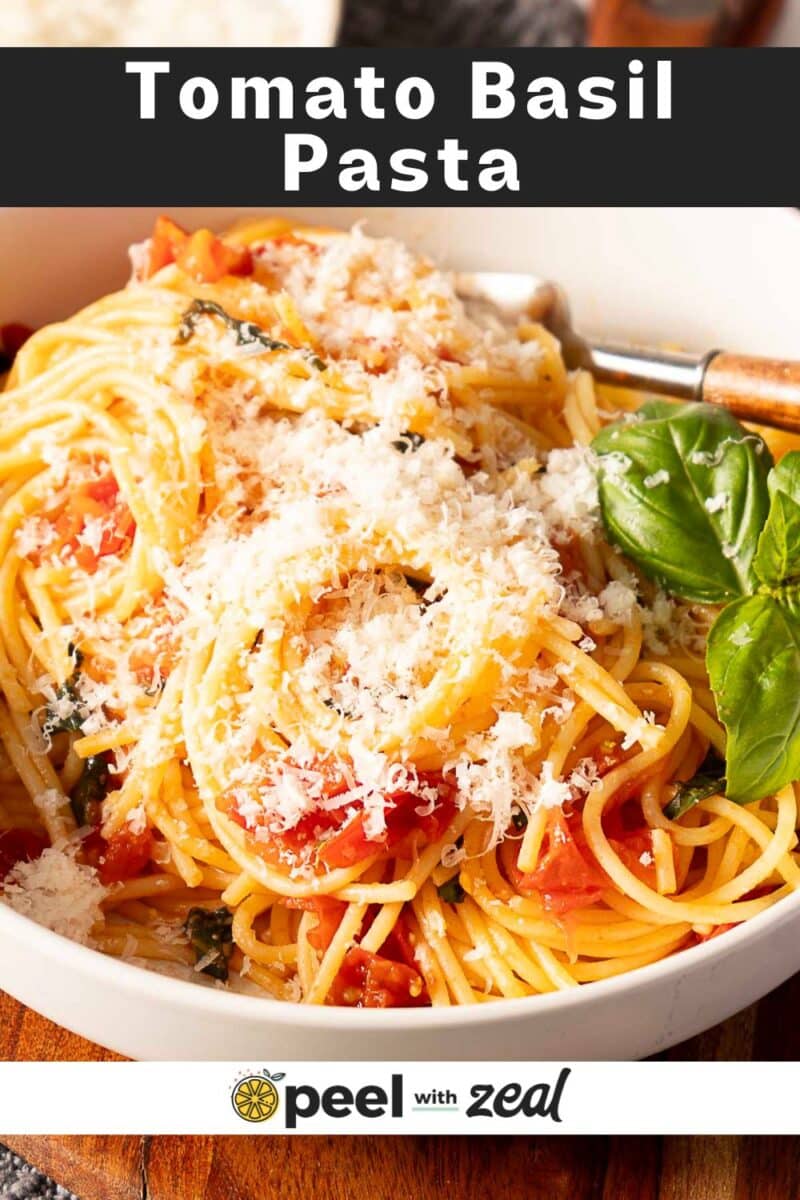 A bowl of Tomato Basil Pasta tossed with rich tomato sauce, garnished with grated cheese and fresh basil, with a fork resting in the bowl. Text overlay reads "Tomato Basil Pasta" and "peel with zeal.
