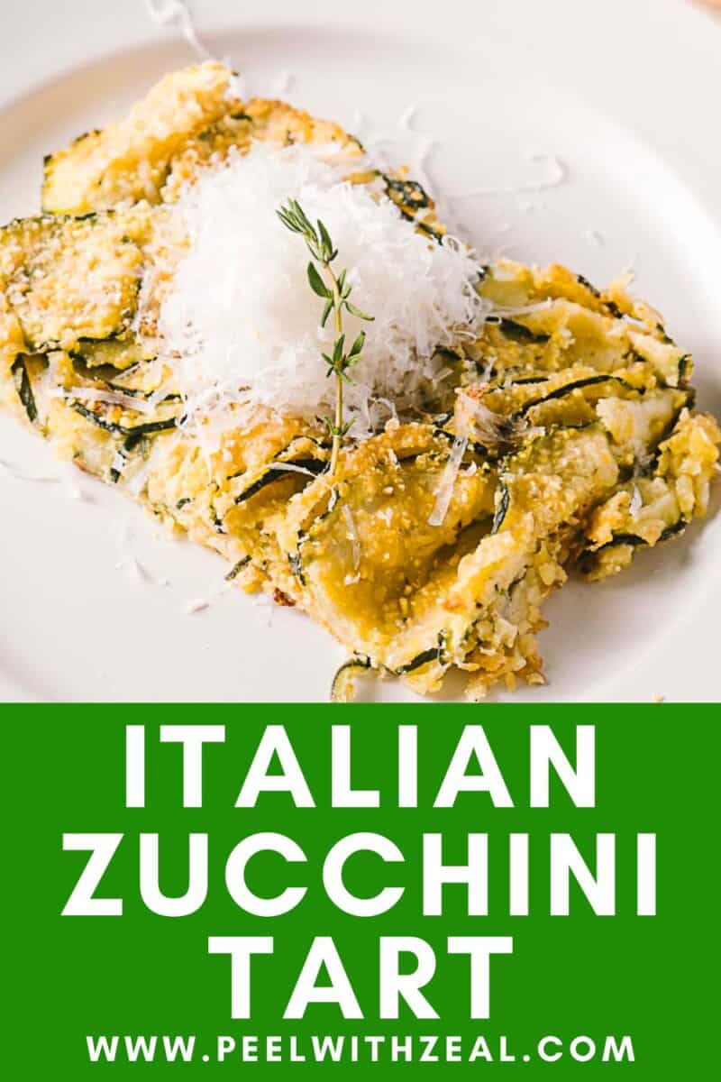 Indulge in a delicious Italian scarpaccia zucchini tart, beautifully topped with grated cheese and a sprig of fresh herbs, all elegantly presented on a white plate. Find more details through the website link below.