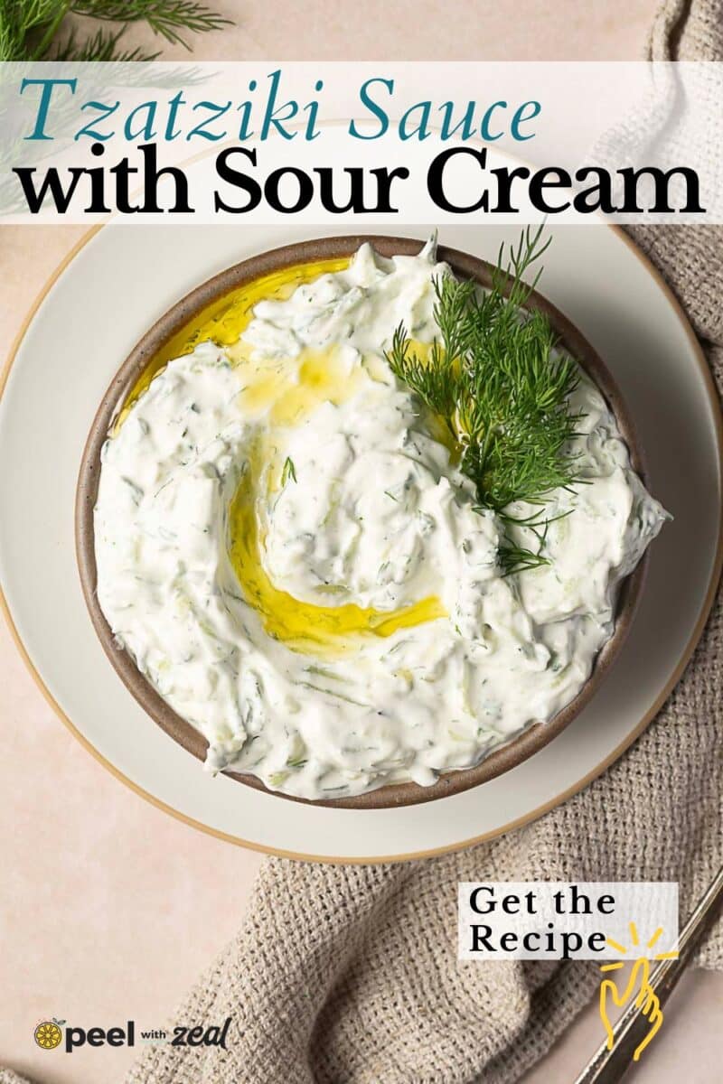 Bowl of Tzatziki Sauce with Sour Cream, garnished with dill and a drizzle of olive oil, sits on a plate with a beige napkin, accompanied by text overlay promoting this easy sour cream recipe.