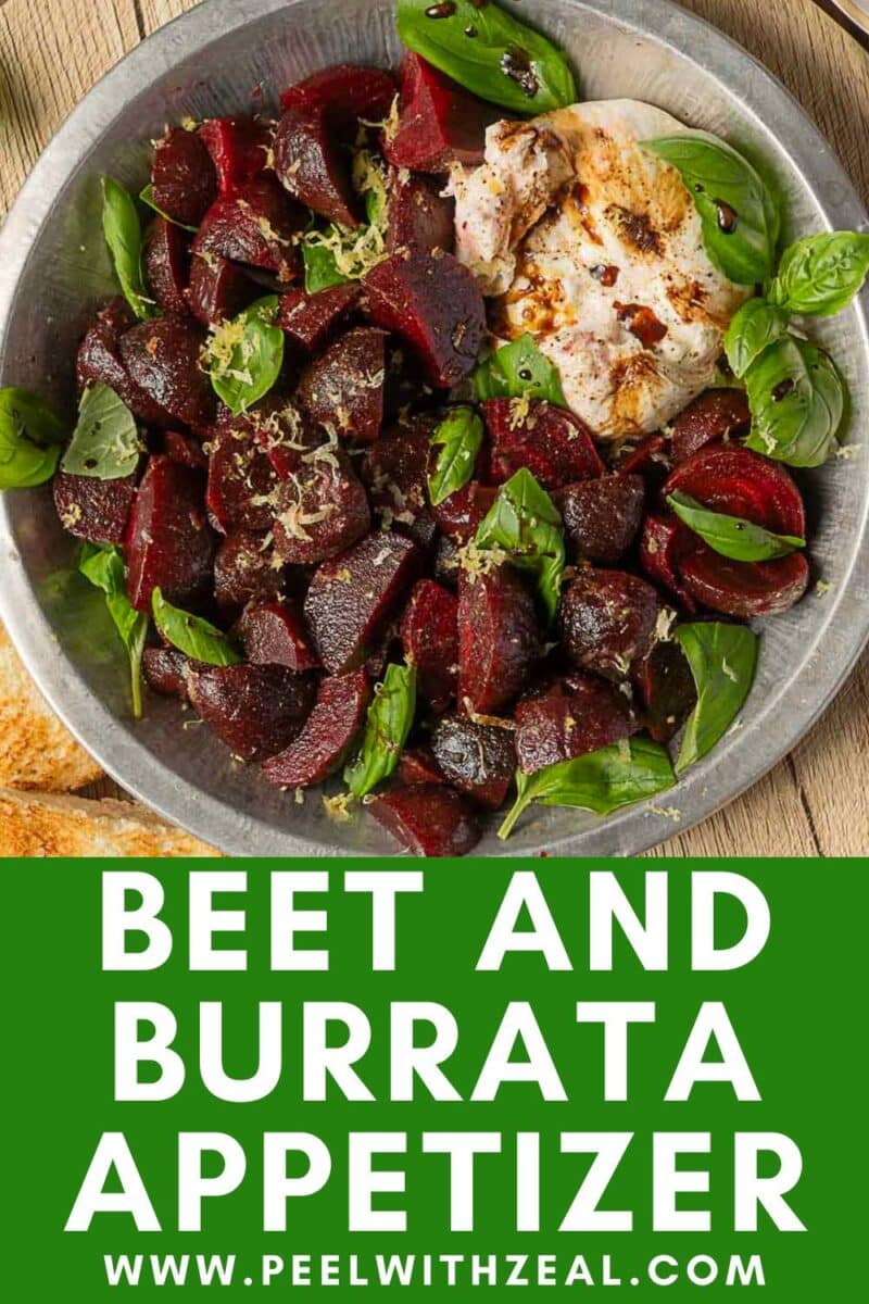 A metal plate with roasted beet pieces, fresh basil, and burrata cheese, garnished with lemon zest, sits next to bread slices on a wooden surface. Text reads "Beet and Burrata Salad Appetizer.