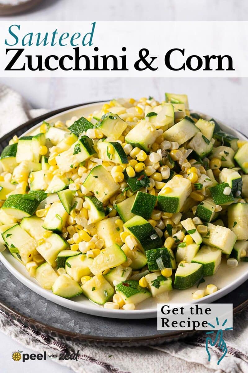 A plate filled with sautéed zucchini and corn, garnished with herbs, sits on a gray surface.