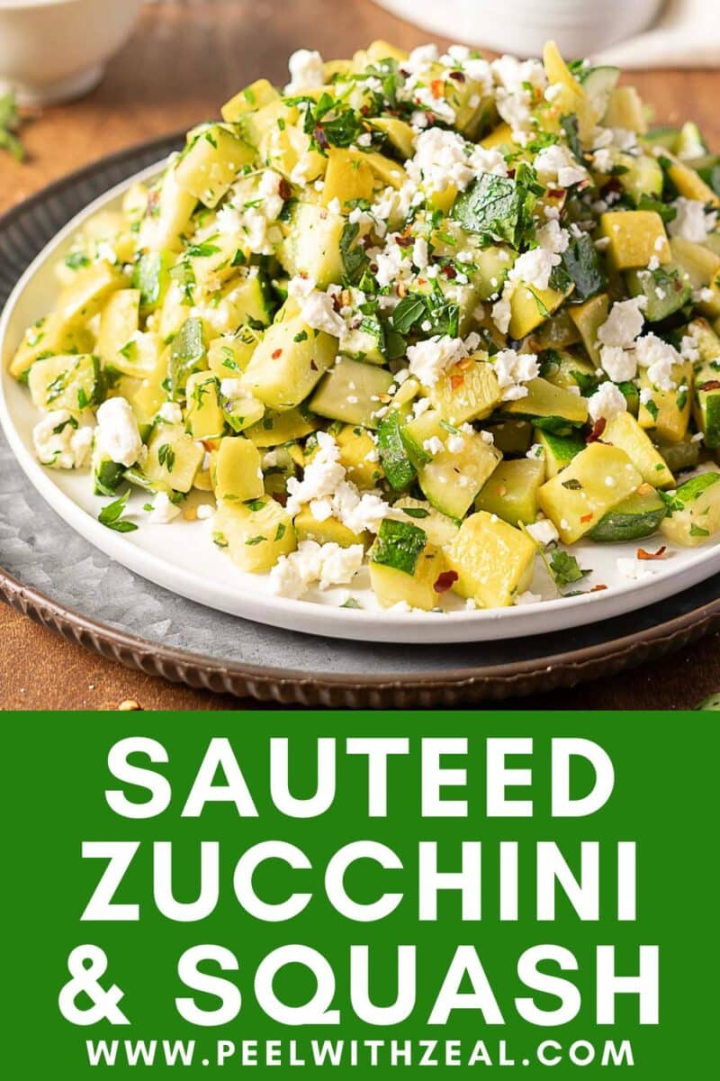 A plate of sauteed zucchini and squash topped with herbs and crumbled cheese sits on a table