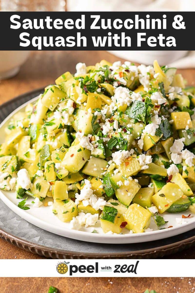 A plate of sauteed zucchini and squash topped with crumbled feta cheese and chopped herbs, elegantly served on a neutral-colored plate.