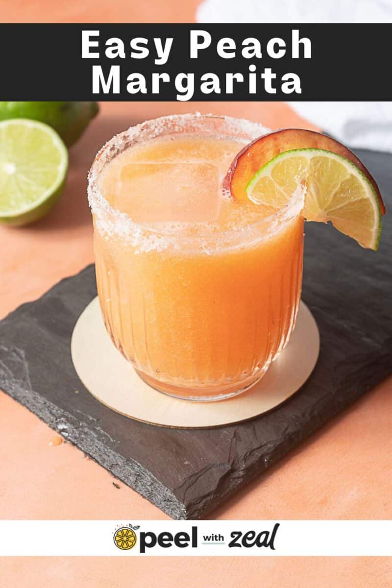A peach margarita garnished with a lime and peach slice sits on a slate coaster, with a half lime in the background. Text reads: "Easy Peach Margarita" and "peel with zeal.