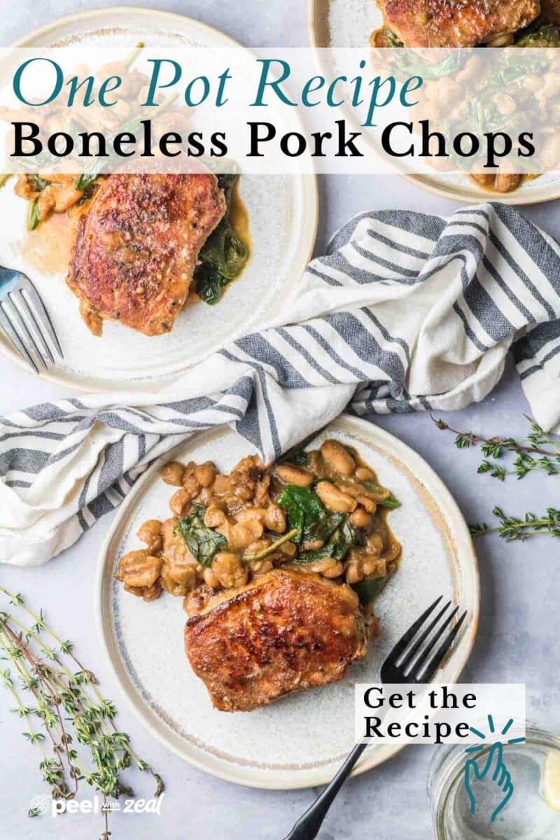 Two plates with boneless pork chops and beans in sauce, garnished with herbs, are set on a light surface next to a striped napkin and a "Get the Recipe" button.