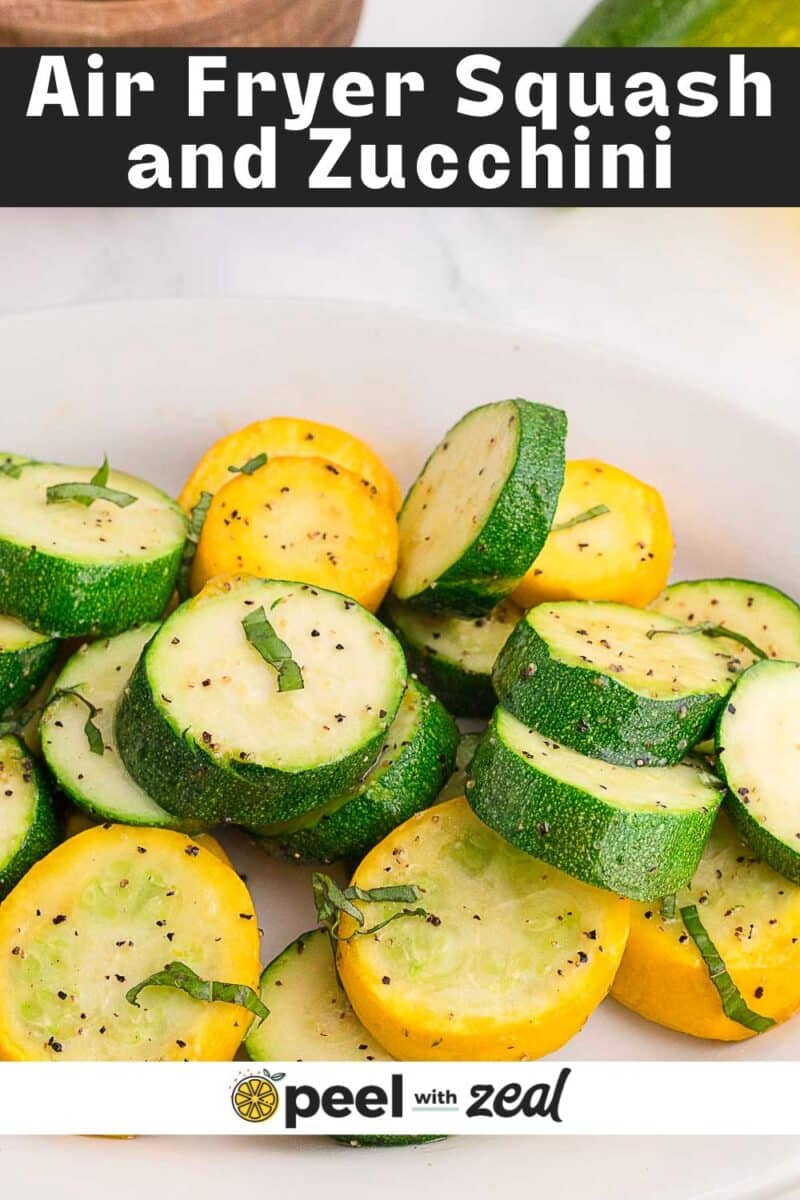 A plate of sliced, cooked yellow squash and zucchini, garnished with fresh herbs and black pepper, with text reading "Air Fryer Zucchini and Squash.