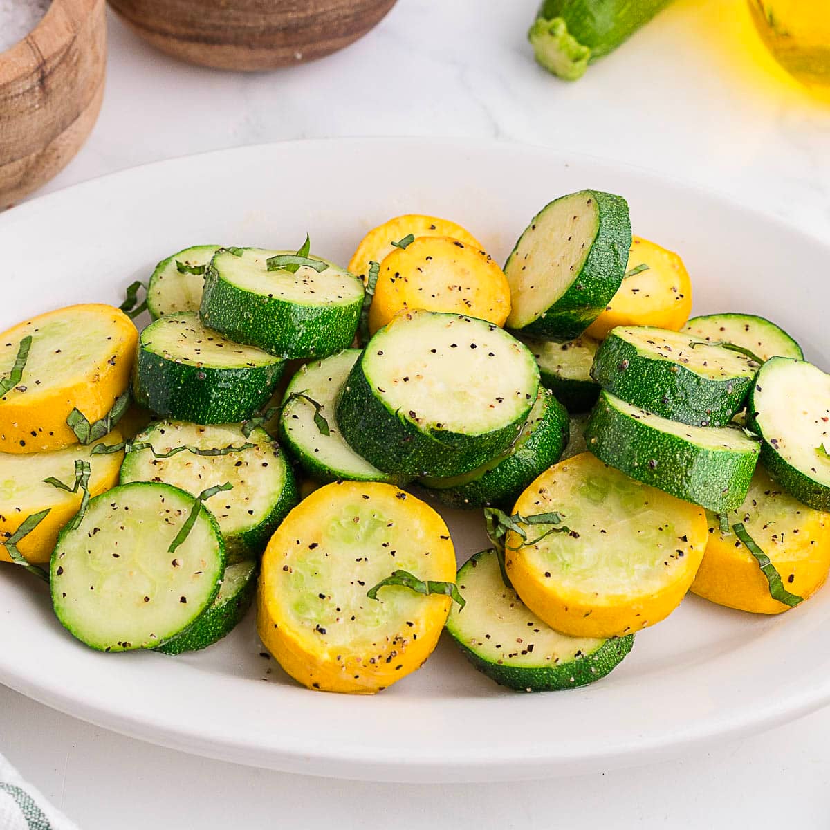 air fryer zucchini and squash on a white plate