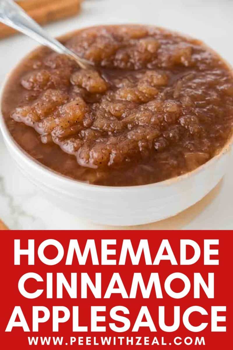 A bowl of homemade slow cooker applesauce with cinnamon and a spoon, placed on a white surface.