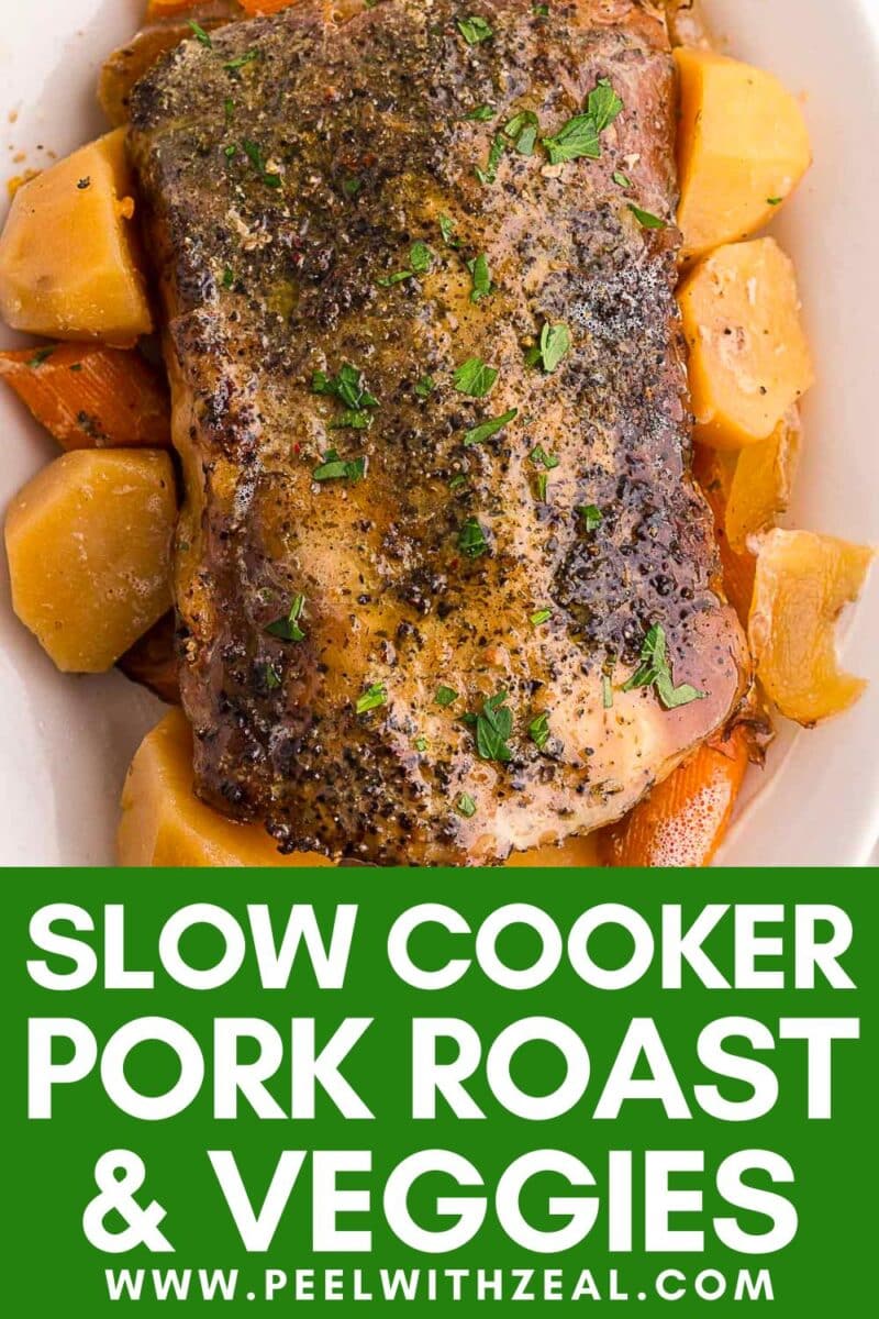 A seasoned slow cooker pork roast sits on a bed of carrots and potatoes in a white dish