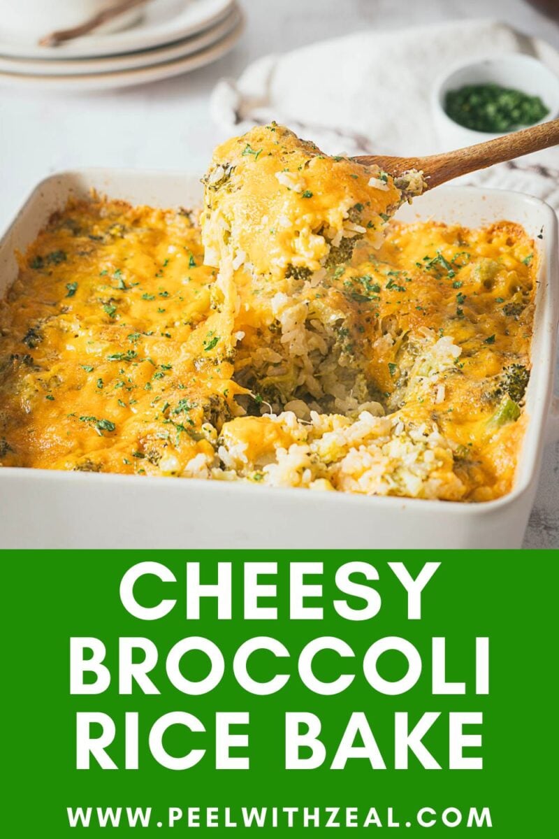 A square dish of cheesy broccoli rice casserole bake topped with melted cheese, with a serving being scooped out; plates and fresh herbs are in the background.