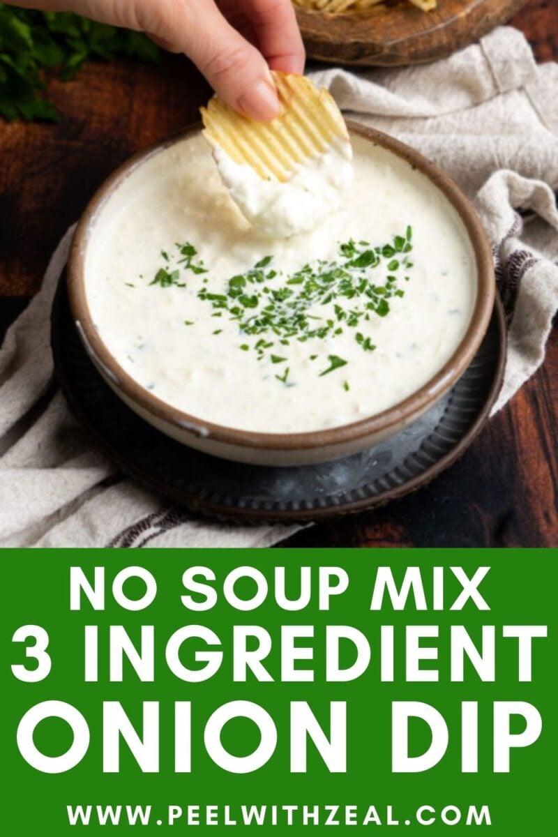 A hand dips a ridged potato chip into a bowl of creamy onion dip garnished with chopped herbs. Text below reads: "No Soup Mix 3 Ingredient Onion Dip www.peelwithzeal.com".