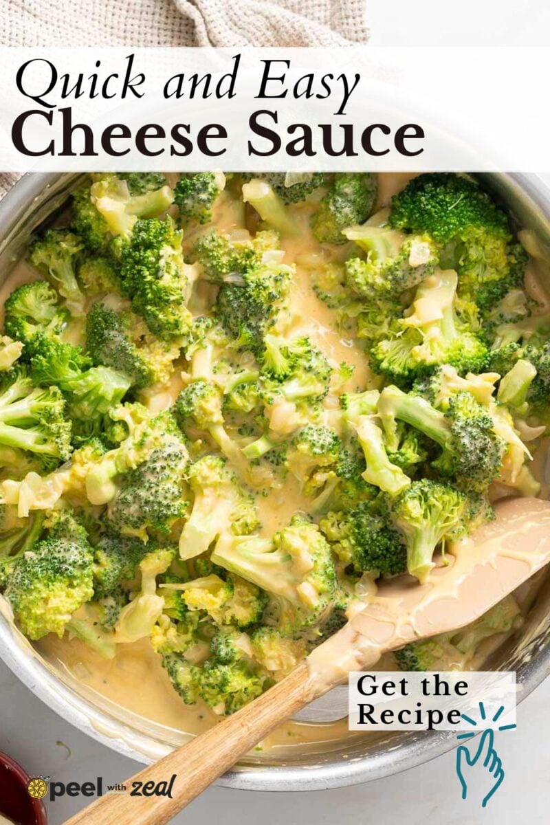 A saucepan filled with broccoli florets covered in a creamy cheese sauce, with a wooden spoon in the pan.