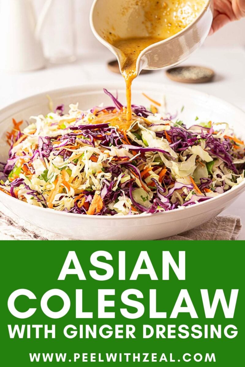 A bowl of Asian coleslaw with shredded cabbage and carrots is topped with ginger dressing being poured from a small bowl. Text reads: "Asian Coleslaw with Ginger Dressing.