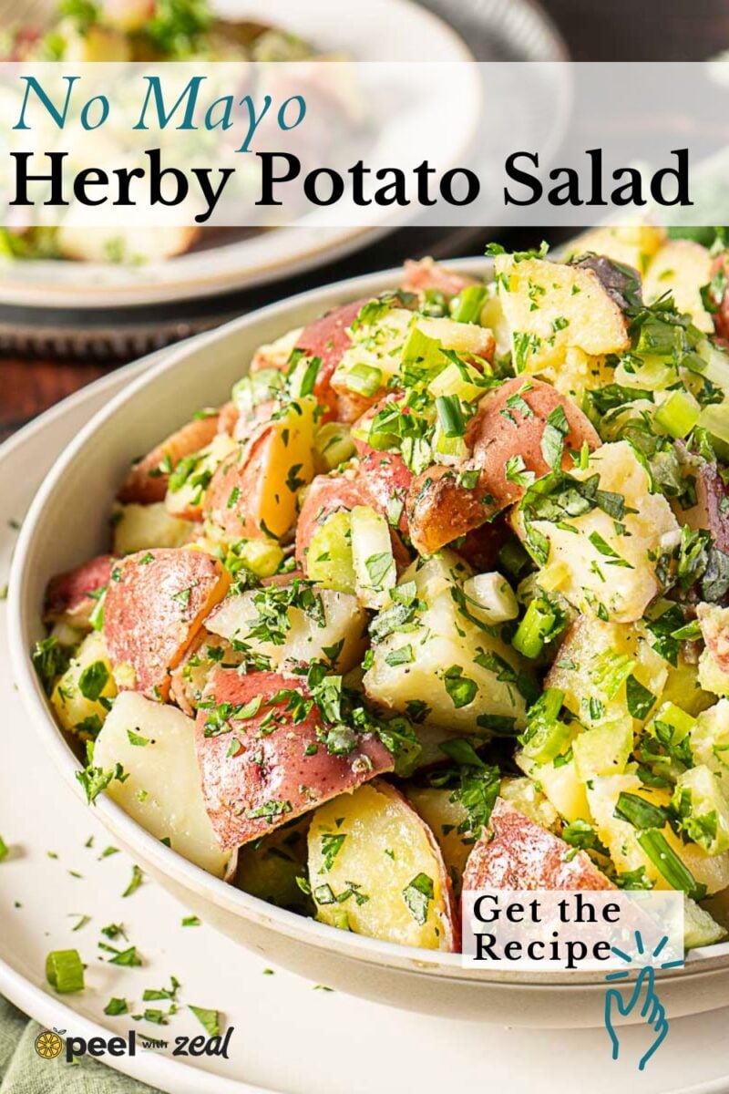 A bowl of herby potato salad made with red potatoes, chopped herbs, and green onions, labeled "No Mayo Herby Potato Salad" with a prompt to get the recipe.
