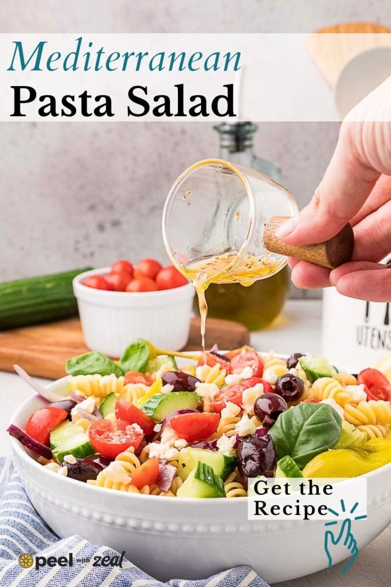 A hand pours dressing onto a bowl of Mediterranean pasta salad with tomatoes, olives, feta, and basil. Text reads "Mediterranean Pasta Salad" and "Get the Recipe.
