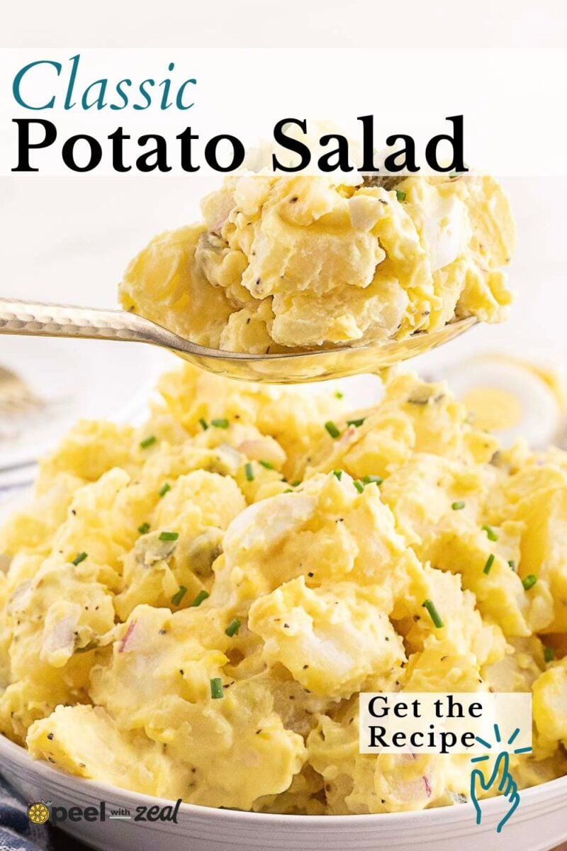 A close-up of a serving spoon lifting creamy Southern Potato Salad with chopped chives from a large bowl. Text reads "Classic Potato Salad" and "Get the Recipe.