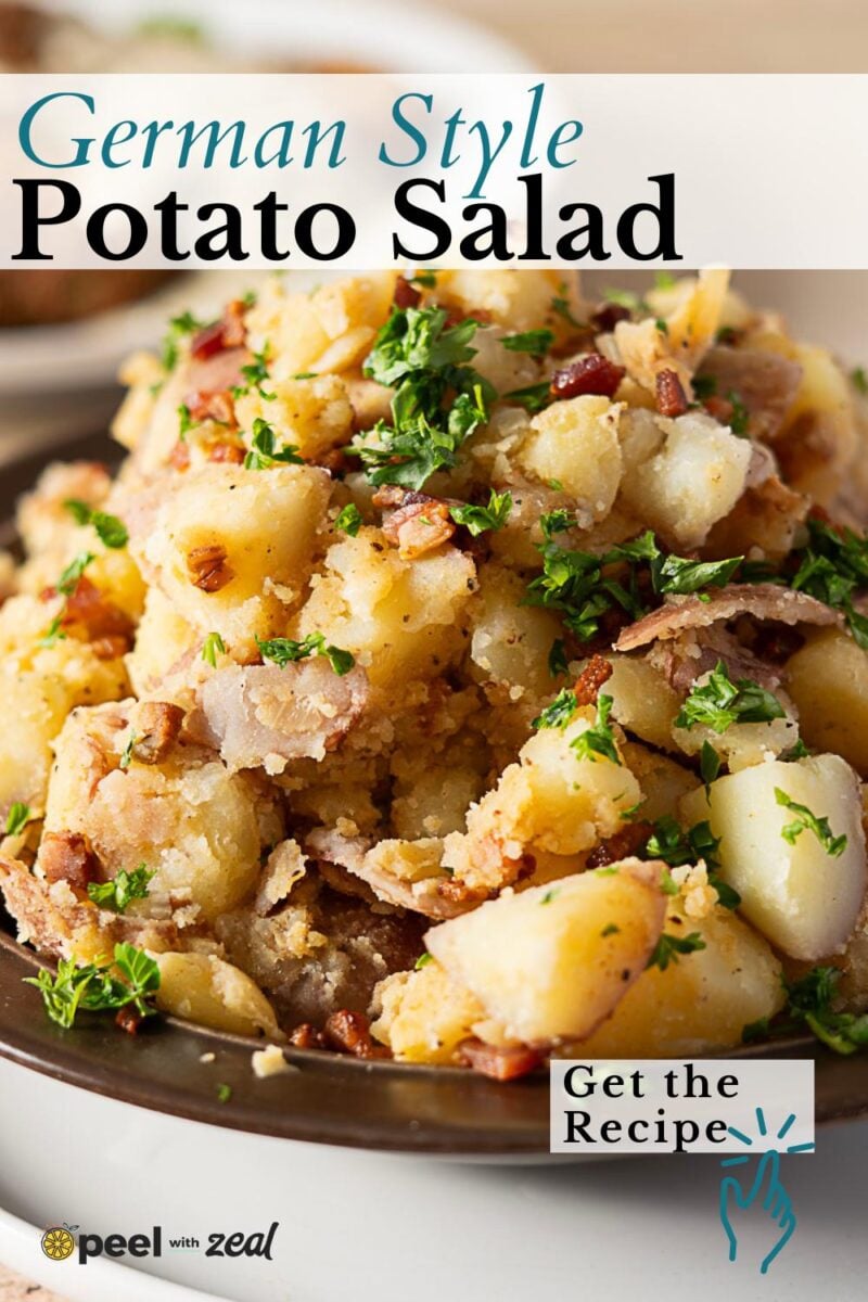A close-up of German-style potato salad with chopped parsley and bacon on a dark plate, featuring text promoting an authentic german potato salad recipe.