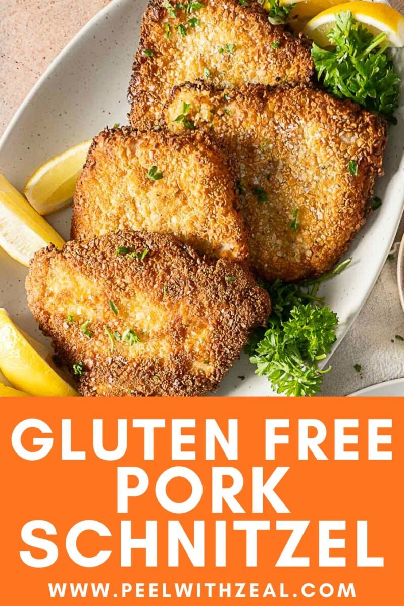 Three pieces of breaded pork schnitzel on a plate with lemon wedges and parsley garnish, viewed from above.