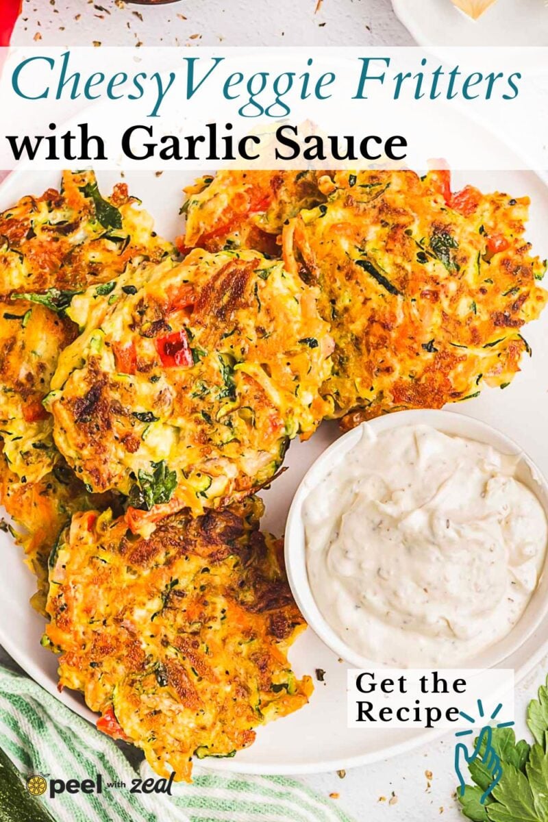 Three golden-brown vegetable fritters rest on a plate beside a bowl of creamy garlic sauce, garnished with fresh herbs and surrounded by inviting text about the recipe. These crispy fritters are perfect for dipping and make a delicious, flavorful appetizer or snack.